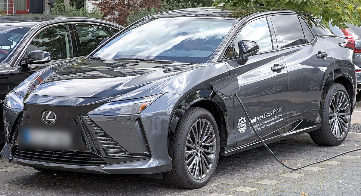 Тёмно-серый электрический Lexus RZ на зарядке, вид спереди