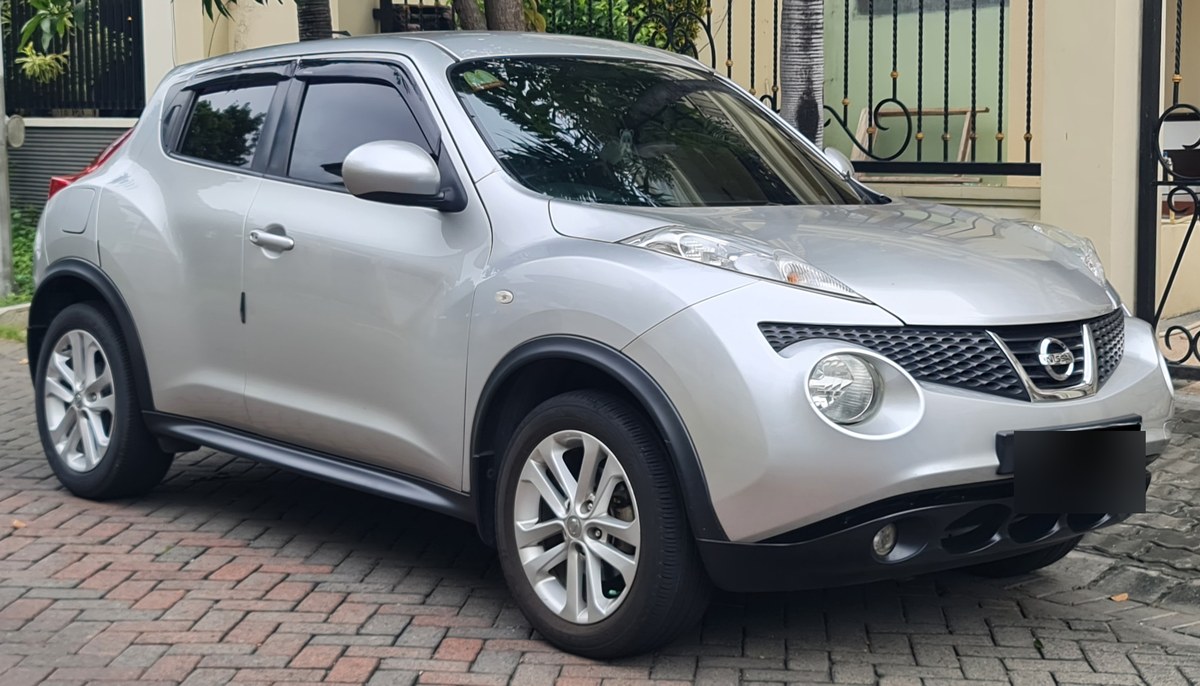 Серебристый Nissan Juke первого поколения (F15), вид спереди в три четверти