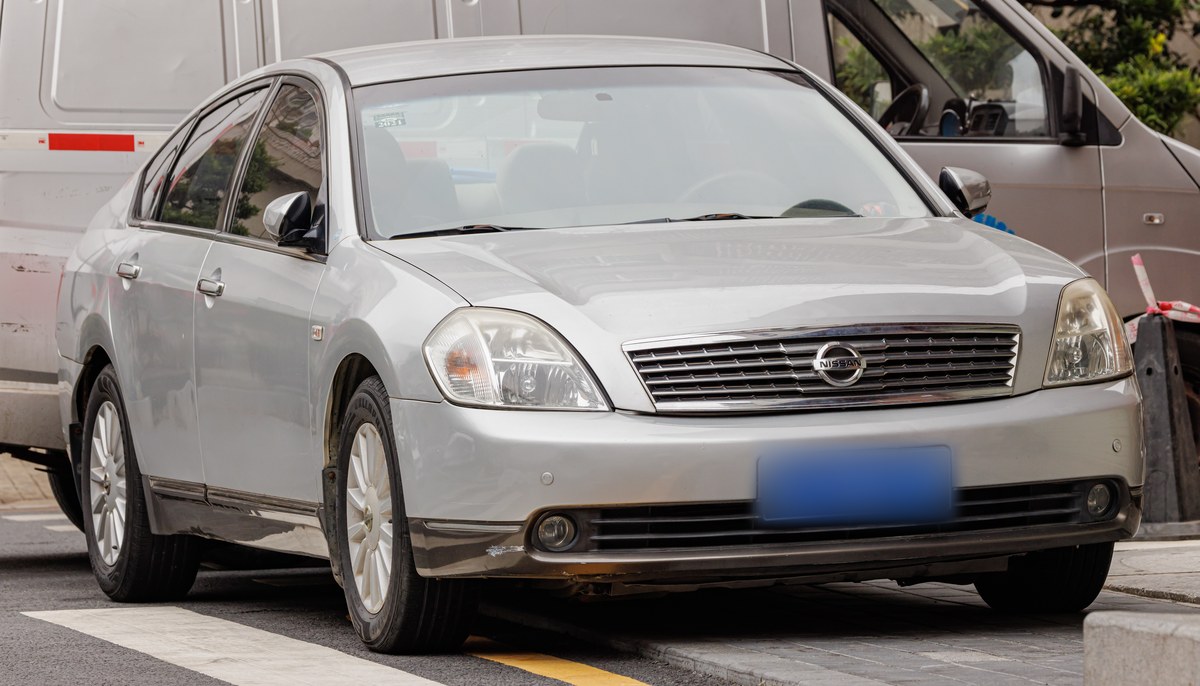 Серебристый Nissan Teana J31 на городской улице, вид спереди слева в три четверти