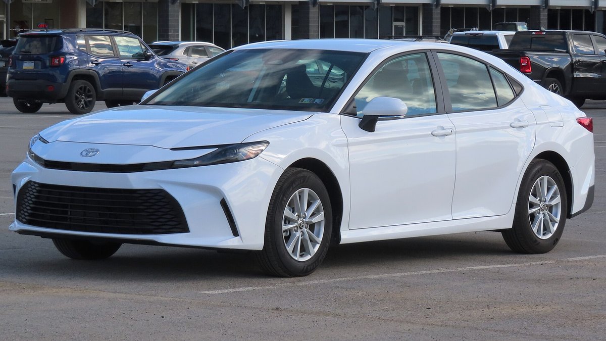 Белая Toyota Camry девятого поколения, вид спереди